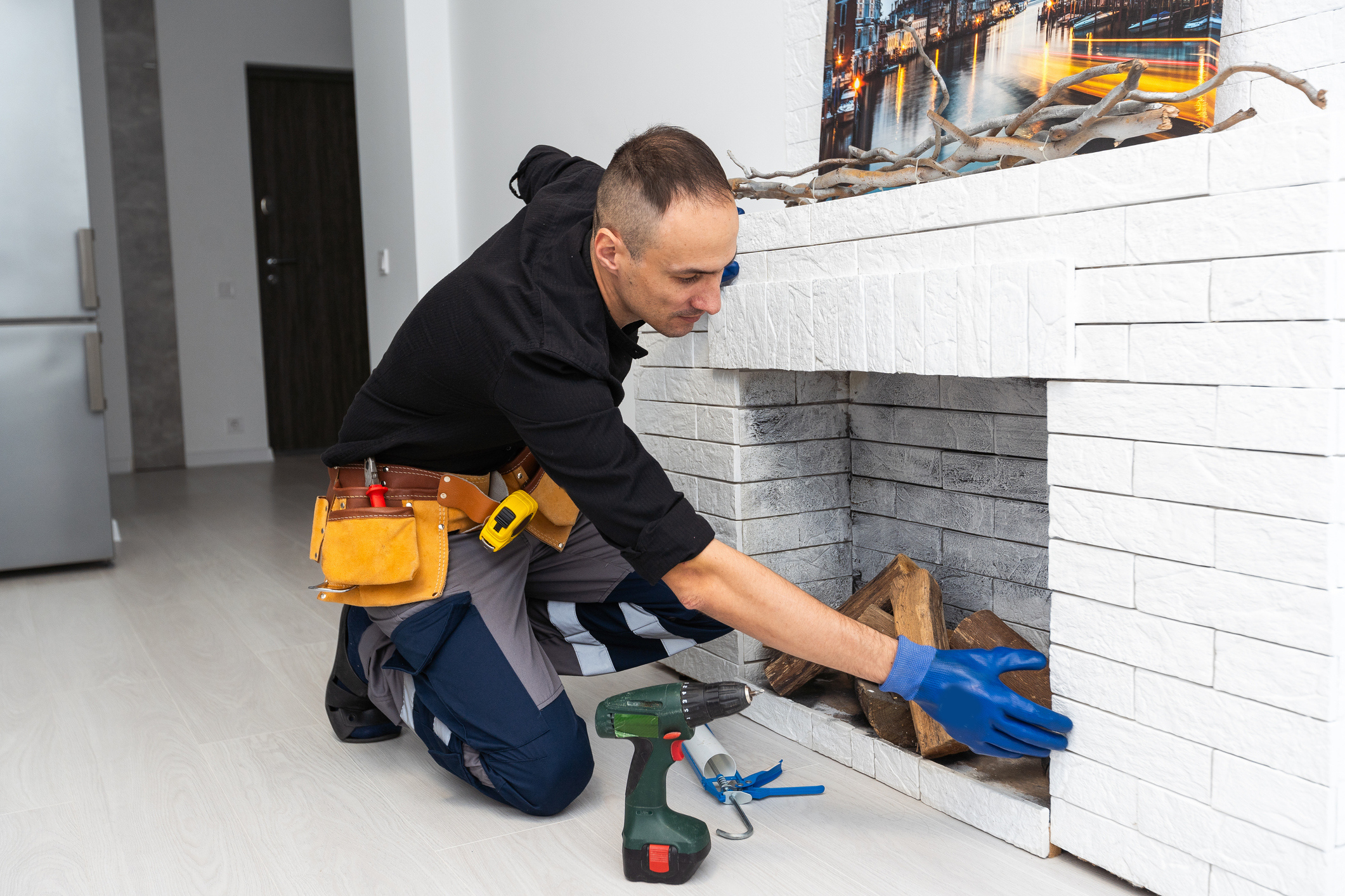 Fireplace installing in white brick wall.